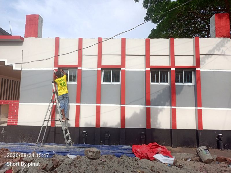 Painter finishing the facade of a school building